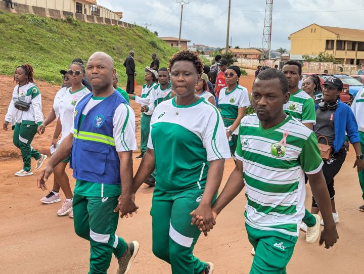 Marcheurs main dans la main en direction de l’esplanade du Stade Omnisport.